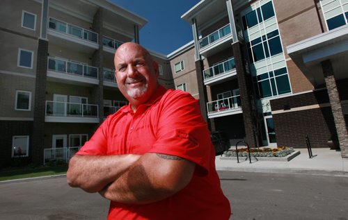 Randy Gauthier poses in front of the Lady Joyce Condo's Lady Joyce Apartment Homes the 90-unit luxury apartment complex the Gauthier Automotive Group built on a piece of surplus land it owned behind its car dealership. The project, which is named after group chairman Jim Gauthiers late wife, has been a smashing success. It opened in March and is already fully leased with a waiting list of 25 people. See Murray McNeill's story. August 11, 2015 - (Phil Hossack / Winnipeg Free Press)