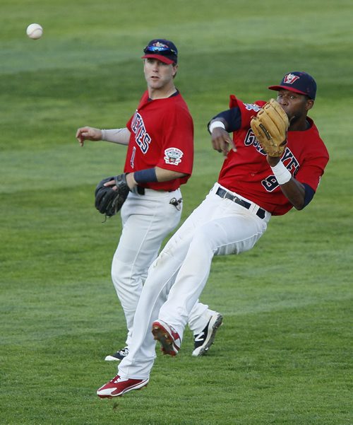 August 11, 2015 - 150811  -  Winnipeg Goldeyes Casio Grider (9) makes the throw to first to get the Sioux Falls Canary out as Brad Boyer (1) looks on in Winnipeg Tuesday, August 11, 2015.  John Woods / Winnipeg Free Press