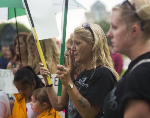 Valerie Head, wife of Joe Head, protests to bring attention to problems with flood channels and the death of her husband at the Manitoba Legislative Building in Winnipeg on Wednesday, Aug. 12, 2015.   Mikaela MacKenzie / Winnipeg Free Press