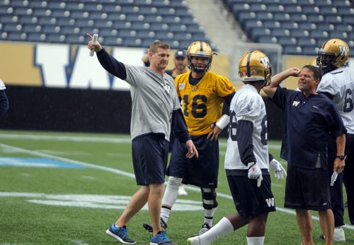Blue Bombers coach Mike O'Shea, left,  calls the team off the field because of bad weather and potential lightning strikes. #16 QB Robert Marve. BORIS MINKEVICH / WINNIPEG FREE PRESS PHOTO August 12, 2015