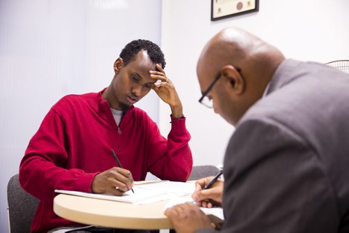 Yahya Samatar talks to his lawyer, Bashir Khan, at the Welcome Place in Winnipeg on Wednesday, Aug. 12, 2015.  Samatar has spent much of the last few days filling out many complex documents with help from staff.   Mikaela MacKenzie / Winnipeg Free Press