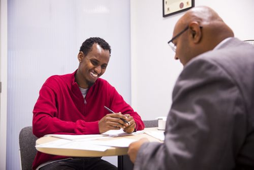 Yahya Samatar talks to his lawyer, Bashir Khan, at the Welcome Place in Winnipeg on Wednesday, Aug. 12, 2015.  Samatar has spent much of the last few days filling out many complex documents with help from staff.   Mikaela MacKenzie / Winnipeg Free Press