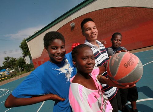 Leonard Monkman, 2nd from right, poses with a group of basketball fans (left to right - Kimmane Malcom, Mzna Mohamedat and Joseph Muhumuza) Elias Magnusson Community Center Friday. See Melessa Matin's story. August 14, 2015 - (Phil Hossack / Winnipeg Free Press)
