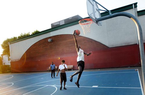 Didi Deng goes up for the shot while Isayas Tekeste (center) watches while playing a little one on one basketball at Magnus Eliasson Community Center's outdoor court Thursday evening. See Melessa Matin's story. August 13, 2015 - (Phil Hossack / Winnipeg Free Press) Wasnt able to get the third kid's name.....