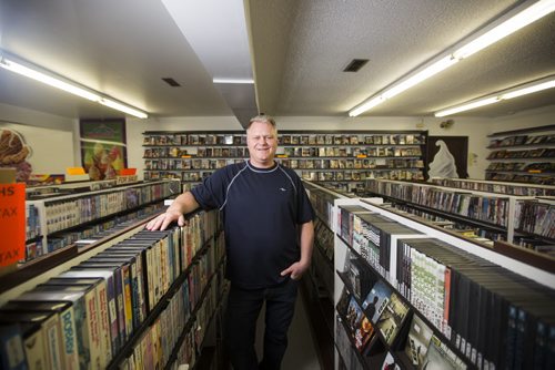 Ken Taylor manages Video 1001, one of the last video stores in Winnipeg, on Mountain Avenue on Friday, Aug. 14, 2015.  The store also has ice cream, slushies, food, lotto tickets, laundry, and more. Mikaela MacKenzie / Winnipeg Free Press