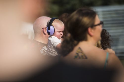 Gracelyn Mcevoy, 8 months, wears ear protection at the Interstellar Rodeo at the Forks in Winnipeg on Friday, Aug. 14, 2015.   Mikaela MacKenzie / Winnipeg Free Press