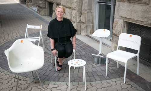 Johanna Hurme, of 5468796 Architecture, poses with a number of white chairs as part of Chair Your Idea. The crowd funding campaign will allow local businesses (as of August 27) to compete by submitting creative initiatives and one white chair to host at their business. The intention is to create a discussion and new ideas around  urban design in Winnipeg. More info www.chairyouridea.ca  August 14, 2015 - Melissa Tait / Winnipeg Free Press