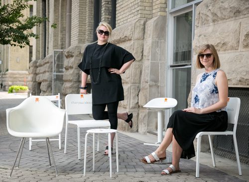 Johanna Hurme, and Caroline Inglis, of 5468796 Architecture, pose with a number of white chairs to promote their initiative Chair Your Idea. The crowd funding campaign will allow local businesses (as of August 27) to compete by submitting creative initiatives and one white chair to host at their business. The intention is to create a discussion and new ideas around  urban design in Winnipeg. More info www.chairyouridea.ca  August 14, 2015 - Melissa Tait / Winnipeg Free Press