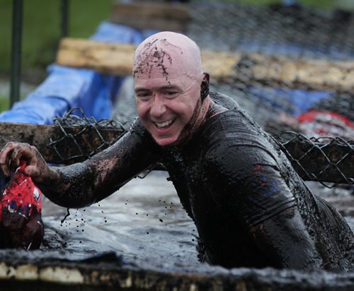 Radio personality Ace Burpee finishes the last mud hurdle in his first round of the Dirty Donkey Mud Race as he raises money for the Children's Hospital with each completed race at the Assiniboine Downs on Saturday  August  15, 2015 Ruth Bonneville  Winnipeg Free Press