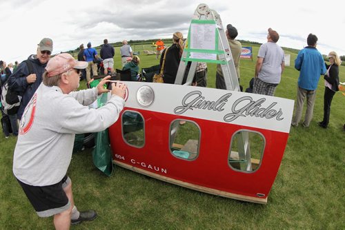 Jeff Kelsey from Winnipeg takes a photo of a piece of the Gimli Glider that was on display at the Gimli Model Airplane Festival just South of the Gimli Speedway Sunday. 150816 August 16, 2015 MIKE DEAL / WINNIPEG FREE PRESS