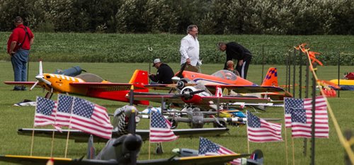 Jeff Esslinger (centre in white), the Air Show chairman, walks past model plans on display at the Gimli Model Airplane Festival today. 150816 - Sunday, August 16, 2015 -  MIKE DEAL / WINNIPEG FREE PRESS
