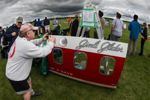 Winnipegger Jeff Kelsey takes a photo of a piece of the Gimli Glider that was on display at the Gimli Model Airplane Festival today. 150816 - Sunday, August 16, 2015 -  MIKE DEAL / WINNIPEG FREE PRESS