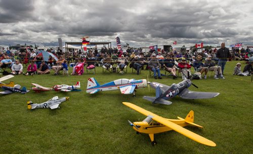 The crowd watches planes fly in the sky above while model plans sit on display at the Gimli Model Airplane Festival today. 150816 - Sunday, August 16, 2015 -  MIKE DEAL / WINNIPEG FREE PRESS