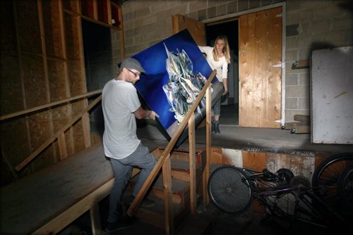 Locked Out-Frame Arts Warehouse at 318 Ross Avenue is shut down by City of WInnipeg today because of fire code violations-Ali Tataryn, rear, and  Travis Cook move inside dark building-See Jessicas story- Aug 17, 2015   (JOE BRYKSA / WINNIPEG FREE PRESS)