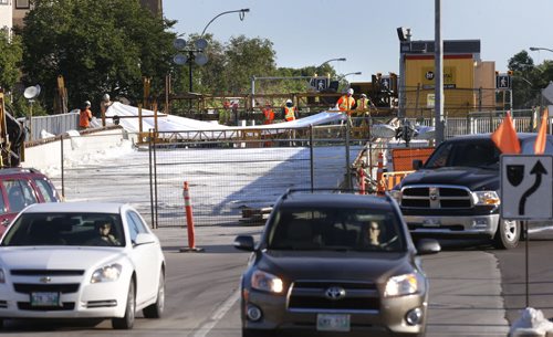 Tuesday morning traffic travels down Sturgeon Rd. to Portage Ave. around the bridge span under construction over Sturgeon Creek.   Wayne Glowacki / Winnipeg Free Press August 18 2015
