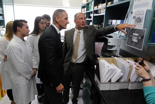 Todays announcementof a combination of private and public funding, totaling $500,000 over the next five years, will advance the work done at the St. Boniface Hospital Research Centre into dementia in seniors and how to better diagnose it. (right) Dr. Ben Albensi shows politition Kevin Chief some stuff in the lab. BORIS MINKEVICH / WINNIPEG FREE PRESS PHOTO August 18, 2015