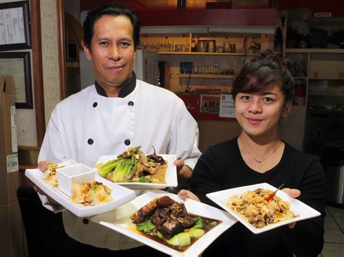 Jeepney Restaurant review - Nelson Olegario and Patricia Patiu hold some nice dishes. BORIS MINKEVICH / WINNIPEG FREE PRESS PHOTO August 18, 2015