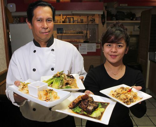 Jeepney Restaurant review - Nelson Olegario and Patricia Patiu hold some nice dishes. BORIS MINKEVICH / WINNIPEG FREE PRESS PHOTO August 18, 2015