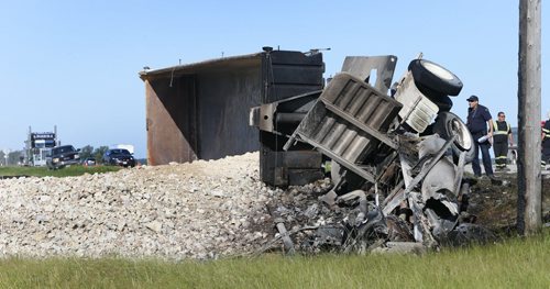 A truck carrying gravel travelling on the Perimeter Hwy. in the east bound lane between Brookside Blvd. and Pipeline Rd. overturned and caught fire. The condition of the driver is not known. Wayne Glowacki/Winnipeg Free Press August 19 2015