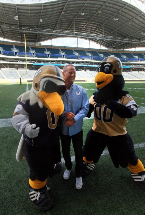 James Deighton (center) is the subject of this weeks In Conversation. Deighton is the man behind the mask of Boomer, the Bombers mascot. Hes been entertaining fans as Boomer since 1988, and says he wont stop until he physically cant put on that costume anymore. See Aiden Geary story. August 19, 2015 - (Phil Hossack / Winnipeg Free Press)