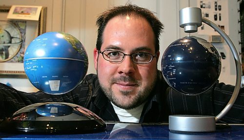 BORIS MINKEVICH / WINNIPEG FREE PRESS  071210 Gizmos Galaxy owner Kevin Mlodzinski poses with some floating globes in his St. Vital Mall store.