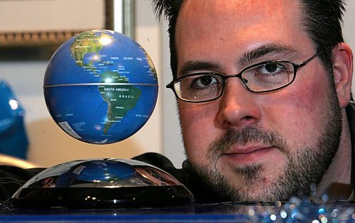BORIS MINKEVICH / WINNIPEG FREE PRESS  071210 Gizmos Galaxy owner Kevin Mlodzinski poses with some floating globes in his St. Vital Mall store.