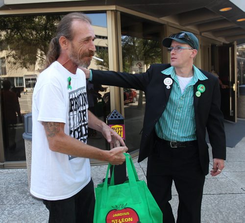 Glenn Price, left, gets a encouragement from medical marijuana activist Steven Stairs outside the Manitoba Law Courts Thursday Price was in court today facing charges after police recently raided his Main St medical marijuana store- See Mike McIntyre  story- Aug 20, 2015   (JOE BRYKSA / WINNIPEG FREE PRESS)