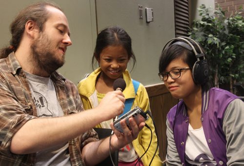 Two students from kids radio camp held at University Of Winnipeg Arabelle Balmana 9yrs, centre, and her sister Arielle go over some radio gear with Radio Camp director James Van Deventer- See Jessicas story- Aug 20, 2015   (JOE BRYKSA / WINNIPEG FREE PRESS)