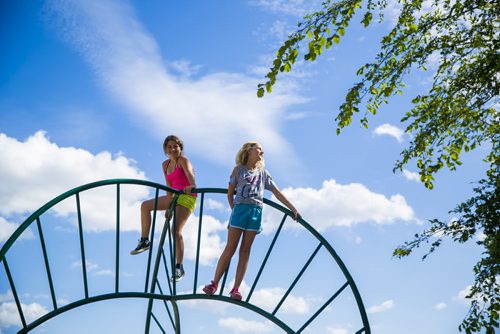 Hailey (left) and Holly, 11, climb on the playground in Saint John's Park in Winnipeg on Thursday, Aug. 20, 2015.   Mikaela MacKenzie / Winnipeg Free Press
