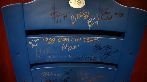 A seat from Canad Inns Stadium signed by the 1988 Grey Cup winning Blue Bombers on the shelf in Riley's Nebraska office. August 20, 2015 - Melissa Tait / Winnipeg Free Press
