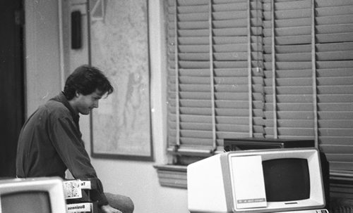 Wayne Glowaki in old Free Press office watching game on TV.  Nov 17, 1990