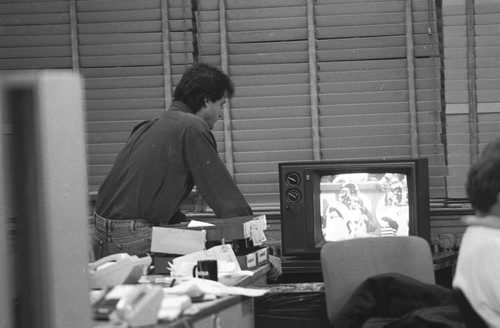 Wayne Glowaki in old Free Press office watching game on TV.  Nov 17, 1990