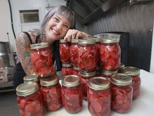 Kimberley Bialkoski founder of flora & farmer, a Winnipeg co. that produces super-creative jams, spreads, relishes and pickles- She poses here with Mexican pickled radishes. (See Dave Sanderson story)- Aug 21, 2015   (JOE BRYKSA / WINNIPEG FREE PRESS) ( Eds name flora & farmer is in lower case)