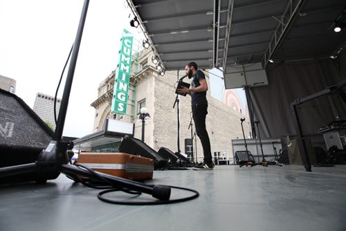 Manuel Unrau of Sound Art does a sound check on one of the microphones during set up of the BBQ Blues Fest taking place in front of the Burton Theatre starting at 6pm tonight (Friday). Standup photo  Aug 21, 2015 Ruth Bonneville / Winnipeg Free Press