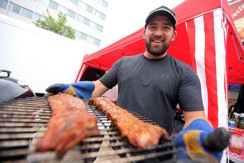Kevin Shmon, from Go Pig or Go Home, with pork back ribs, at the Winnipeg BBQ and Blues festival, Friday, August 21, 2015. (TREVOR HAGAN/WINNIPEG FREE PRESS)