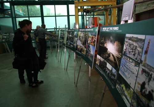 People look at photographs of drawings of the Forks plans for more development Saturday which are on display in centre court.  Aug 22, 2015 Ruth Bonneville / Winnipeg Free Press