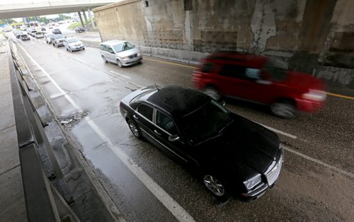 One of two stalled cars sit under the Jubilee Underpass after heavy rains hit the city, Saturday, August 22, 2015. (TREVOR HAGAN/WINNIPEG FREE PRESS)