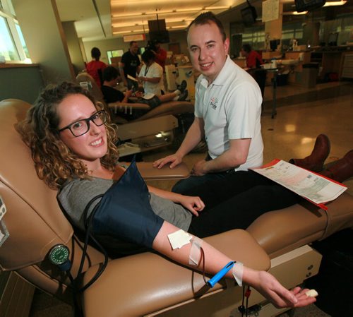 Jonathan Niemczak of Pride Winnipeg and his Blood donation Ally Stephanie English at Canadian Blood Services Monday. See Aidan Geary's story re: Winnipegs first ally blood donor clinic, where eligible individuals (or allies) are invited to donate blood on behalf of their male friends, family or loved ones who arent allowed  to because of their sexual preferences. August 24, 2015 - (Phil Hossack / Winnipeg Free Press)