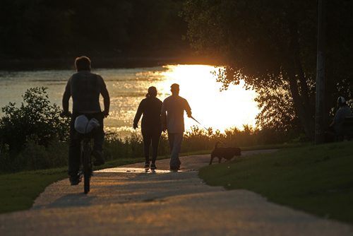 People enjoy and evening walk on the paths next to the Red River in Ernie O'Dowda Memorial Park near Midwinter Ave. Wednesday evening.   Standup photo  Aug 26, 2015 Ruth Bonneville / Winnipeg Free Press