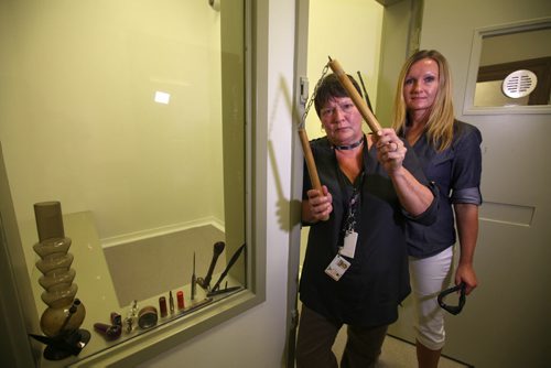 Shauna Curtin with Manitoba Justice and Manitoba's Chief Sheriff Darcy Blackburn (right, blond) stand next to the door to a holding cell as they display contraband items that are confiscated by Sheriff Officers that are brought in by people coming into the Law Courts building.  See Mike McIntyre's story.   Ruth Bonneville, Aug 28/15 Winnipeg Free Press