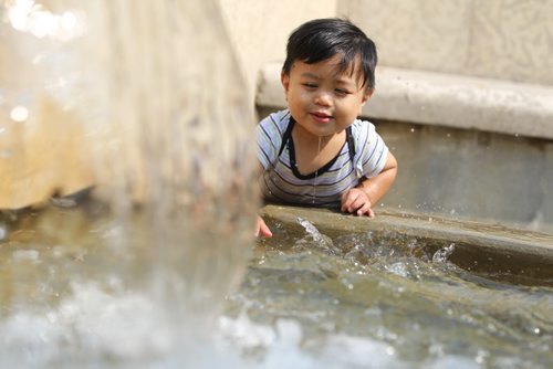 One and a half-year-old Kenzy Ramilo plays in the fountain behind the Manitoba Legislative Building Friday afternoon while out on a walk with his Grandmother. Standup photo   Aug 27, 2015 Ruth Bonneville / Winnipeg Free Press