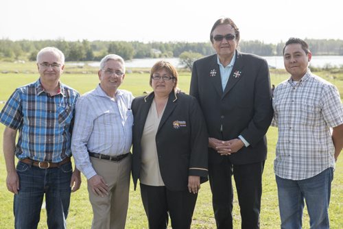 DAVID LIPNOWSKI / WINNIPEG FREE PRESS 150828 August 28, 2015  (L-R)  The Manitoba East Side Road Authority VP of Engineering and Construction Glenn Fempel, CEO of The Manitoba East Side Road Authority, Ernie Gilroy, Chief Jackie Everett, Aboriginal and Norther Affairs Minister Eric Robinson, and The Manitoba East Side Road Authority Aboriginal Relations and economic development officer Jeremy Daniels pose for a photo during an event that included an announcement for the future site of a bridge over Pigeon River at Berens River Friday August 28, 2015 in Berens River. The bridge is part of the next stage of construction of the east-side road by The Manitoba East Side Road Authority. This stage would link Berens River to Bloodvein to the south.