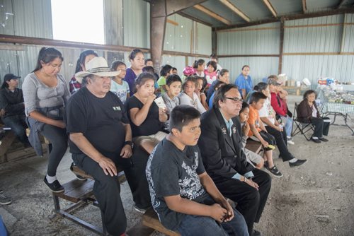 DAVID LIPNOWSKI / WINNIPEG FREE PRESS 150828 August 28, 2015  A crowd watch a video with Aboriginal and Northern Affairs Minister Eric Robinson and Chief Jackie Everett during an event that included an announcement for the future site of a bridge over Pigeon River at Berens River Friday August 28, 2015 in Berens River. The bridge is part of the next stage of construction of the east-side road by The Manitoba East Side Road Authority. This stage would link Berens River to Bloodvein to the south.