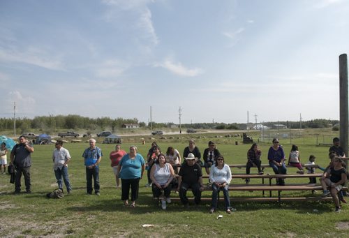 DAVID LIPNOWSKI / WINNIPEG FREE PRESS 150828 August 28, 2015  A crowd watch a video with Aboriginal and Northern Affairs Minister Eric Robinson and Chief Jackie Everett during an event that included an announcement for the future site of a bridge over Pigeon River at Berens River Friday August 28, 2015 in Berens River. The bridge is part of the next stage of construction of the east-side road by The Manitoba East Side Road Authority. This stage would link Berens River to Bloodvein to the south.