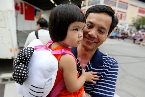 Trong Luong holding his daughter, Cindy, who is almost 2 years old, at the Chinatown Street Festival, Saturday, August 29, 2015. (TREVOR HAGAN/WINNIPEG FREE PRESS)