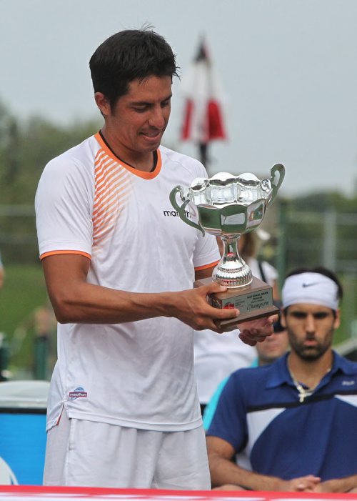 Gonzalo Escobar from Ecuador accepts the winning trophy after the Finals of the 2015 Winnipeg National Bank Challenger against South African Fritz Wolmarans Sunday at the Winnipeg Lawn Tennis Club. 150830 August 30, 2015 MIKE DEAL / WINNIPEG FREE PRESS