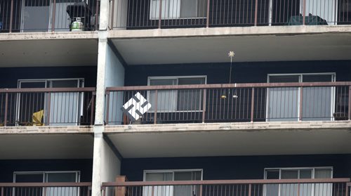 A swastika on an apartment balcony about halfway up on Le Chateau York, York and Smith. It was taken down moments after picture was taken. Nick Martin story. Wayne Glowacki / Winnipeg Free Press August 31  2015