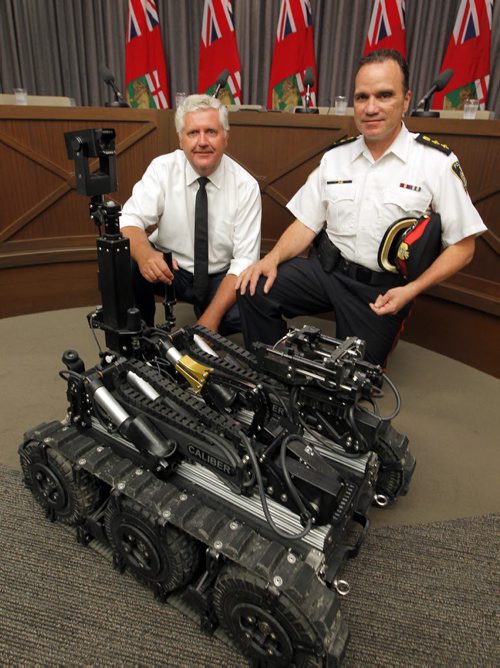 MB Attorney General Gord Mackintosh and Deputy Chief Danny Smyth, investigative services, Winnipeg Police Service (WPS).  Criminal Property Forfeiture Grants for the RCMP and WPS. After the announcement, WPS will provide a short demonstration of a robot used by its bomb squad, which was purchased with funding from last years grant. BORIS MINKEVICH / WINNIPEG FREE PRESS PHOTO August 31, 2015