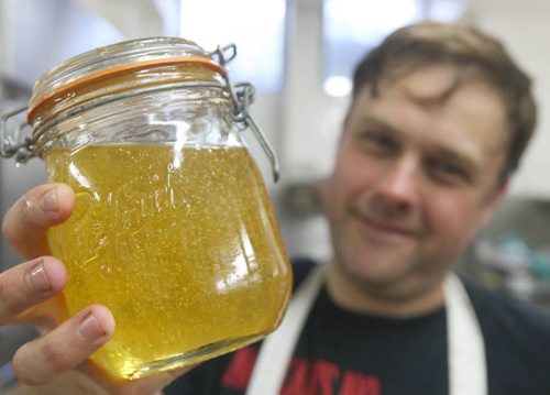 James Patterson with fresh honey from this honey extractor- He sells honey to the hotel and very soon hopes that the City Of Winnipeg will allow them to place 5 hives on the roof of the hotel-  See J Bryksa 49.8 Bee photo story - Aug 31, 2015   (JOE BRYKSA / WINNIPEG FREE PRESS)
