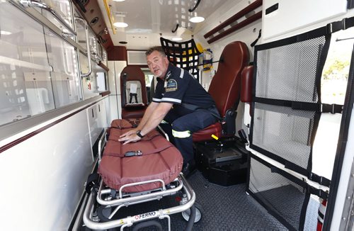 Brent Curry, a front line Paramedic in Portage la Prairie gives a tour to the media of a the new replacement ambulance parked in front of the Manitoba Legislative Bld. Tuesday for the news conference. Brent demonstrates how a seat belted Paramedic in  the new chair can safely care for a patient.  The province announced it has purchased 52 new ambulances with new suspension system and other features.   Larry Kusch story Wayne Glowacki / Winnipeg Free Press Sept.1  2015